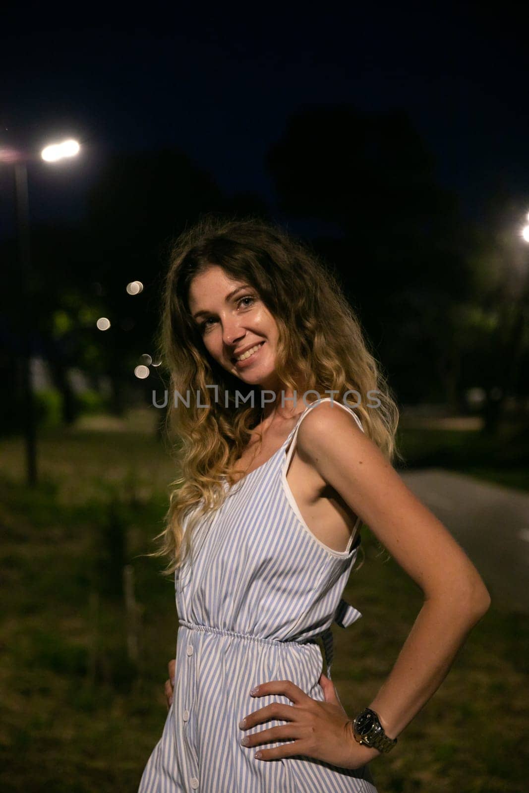 Portrait of smiling woman in summer dress at night