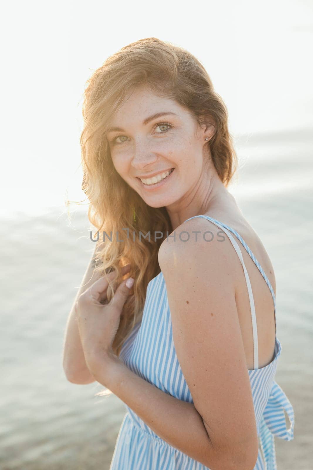 Portrait of a beautiful smiling woman in a summer light dress by Simakov
