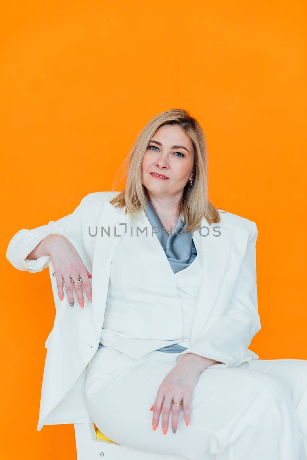 adult woman in white business suit in orange office