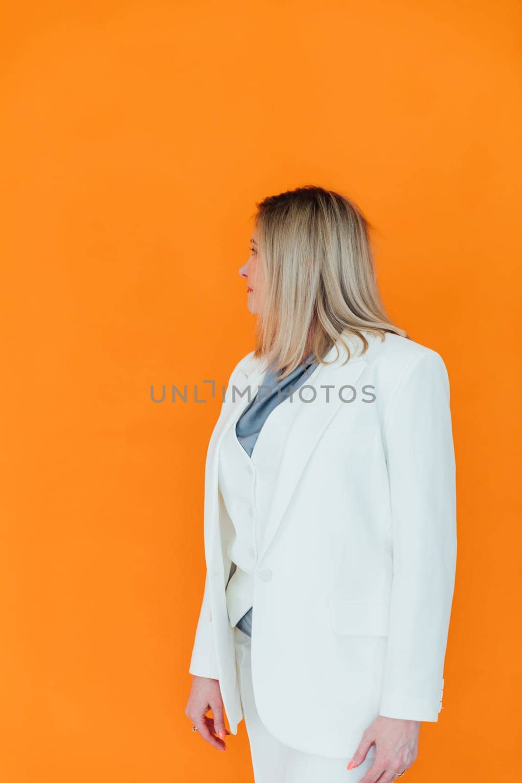 adult woman in white business suit in orange office