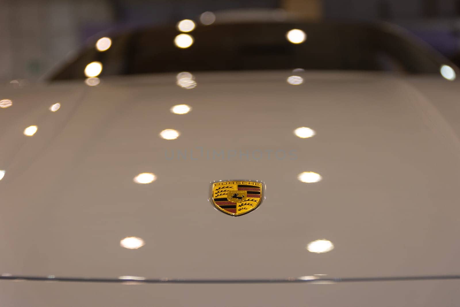 12 MAY 2023, Lisbon, Porugal, Electric car Show in International Fairy of Lisbon - A white car with a yellow emblem on it