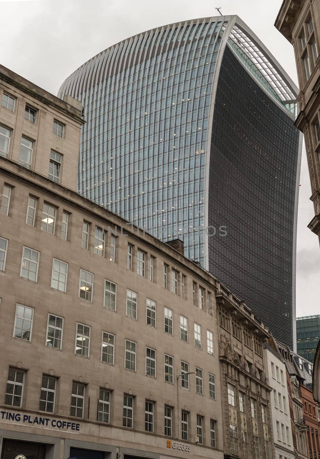 London, UK - Nov 27, 2023 - The 20 Fenchurch Street Walkie Talkie Building in London overshadows surrounding older buildings. Space for text, Selective focus.