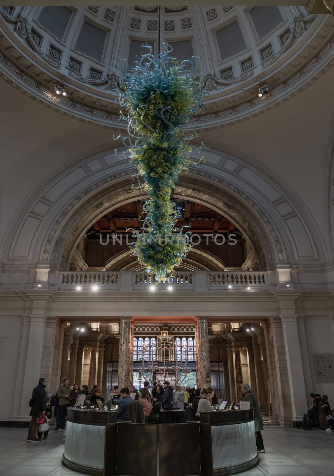 London, UK - Nov 27, 2023 - Metre high, View of Blown glass chandelier in Victoria and Albert Museum hall. Beautiful interior architecture design of The Victoria and Albert Museum. Inner decor. Selective focus.