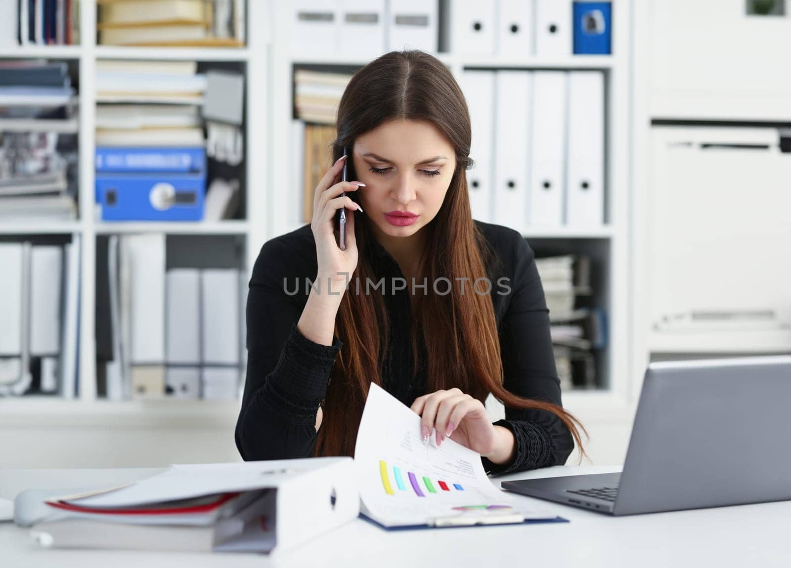 Beautiful brunette smiling businesswoman hold in arm cellphone in office workplace portrait. Stay in touch negotiate meeting job white collar busy life style electronic device store training concept