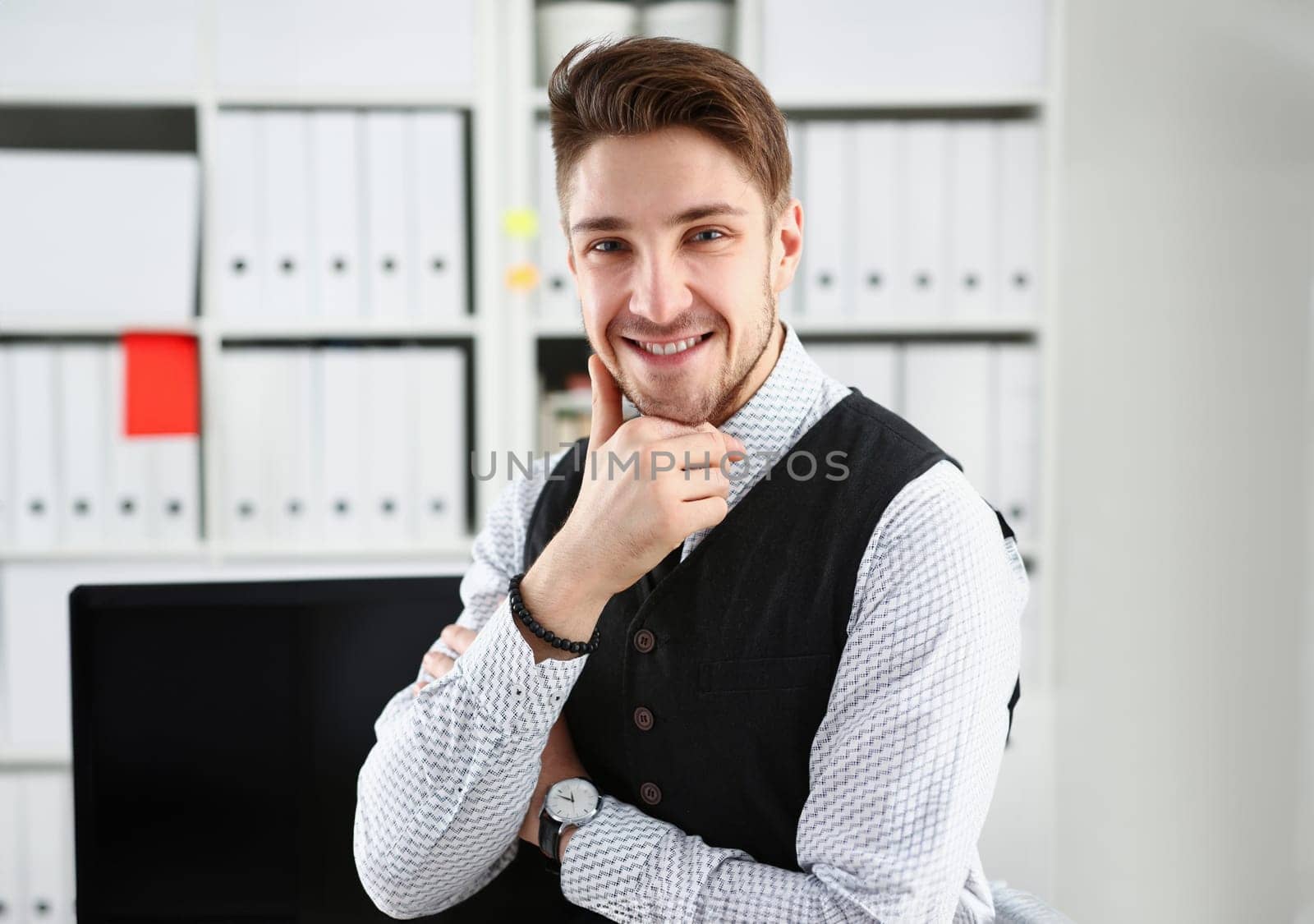 Handsome man in suit and tie stand in office looking in camera hands crossed on chest. White collar dress code modern office lifestyle graduate college study profession idea coach train concept