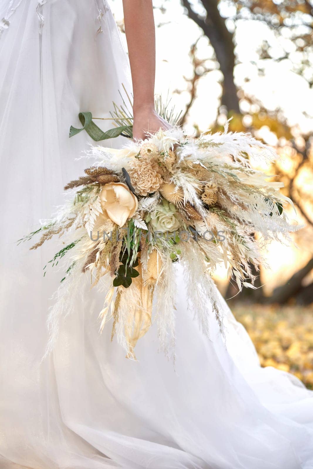 hands of the bride holding beautiful autumn bouquet