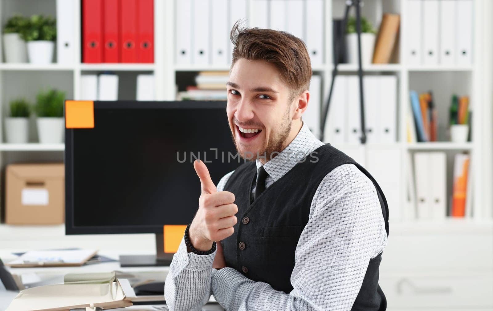 Businessman showing thumbs up in office busines peope