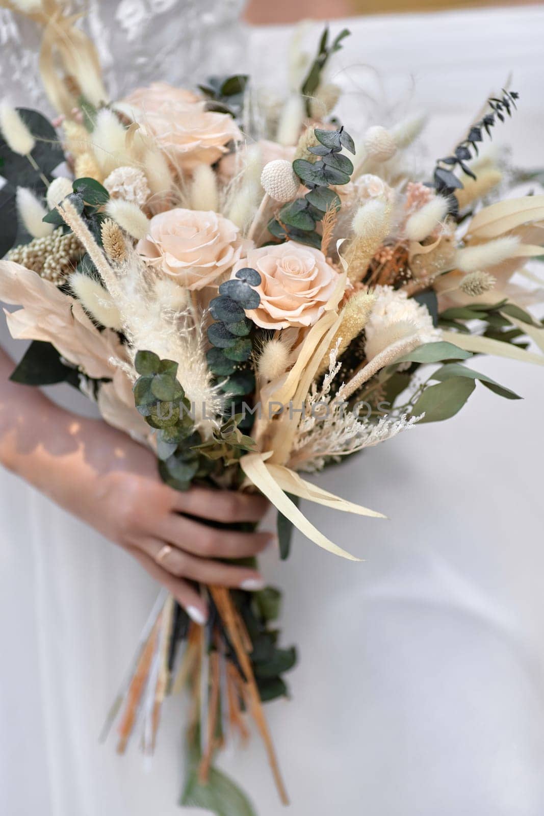 hands of the bride holding beautiful autumn bouquet outdoor