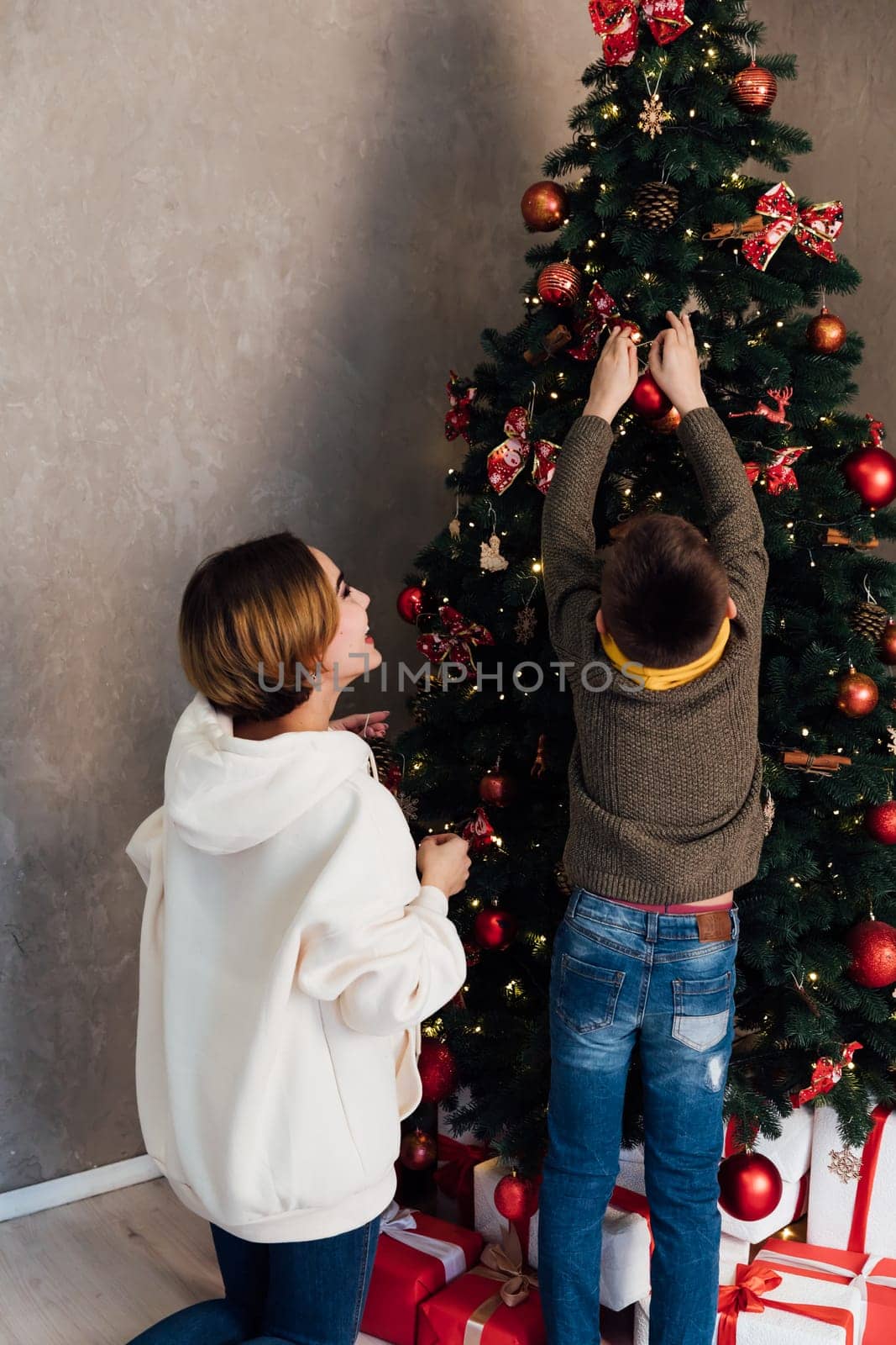 Mom and son decorating the Christmas tree, holiday, New Year, Christmas