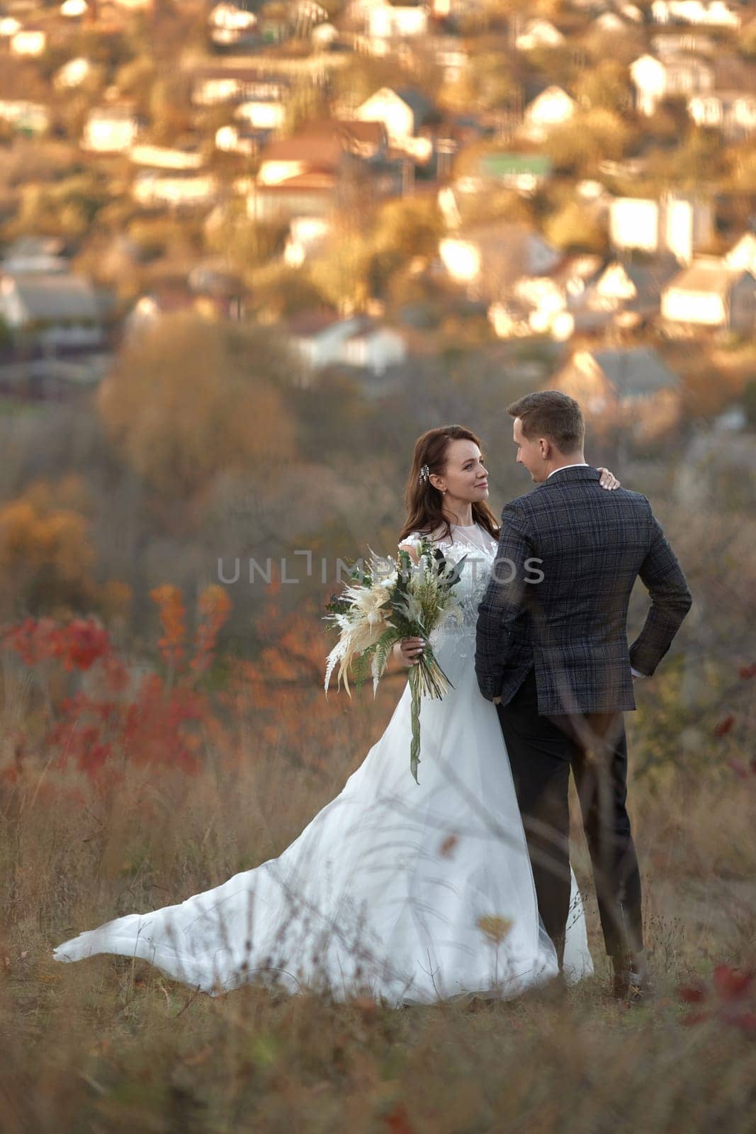 bride in white wedding dress and groom outdoor by erstudio