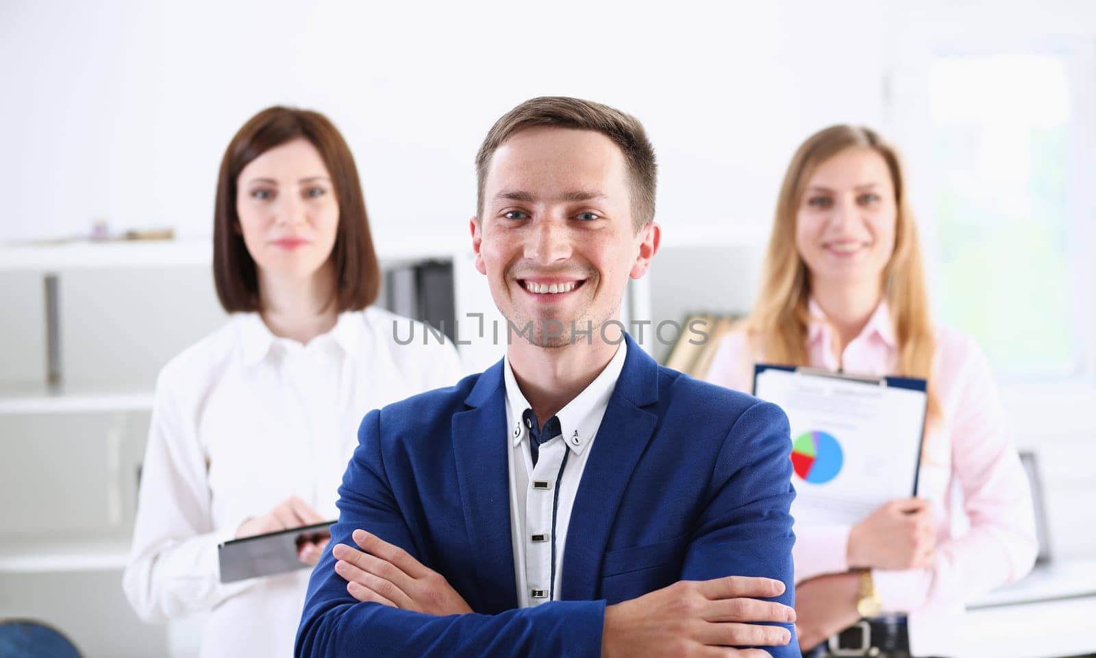 Group of smiling people stand in office looking by kuprevich