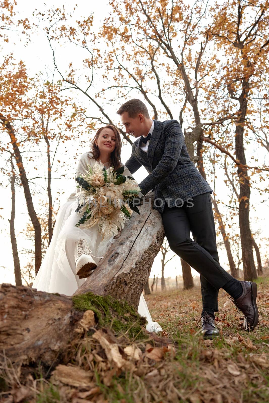 bride in white wedding dress and groom outdoor by erstudio