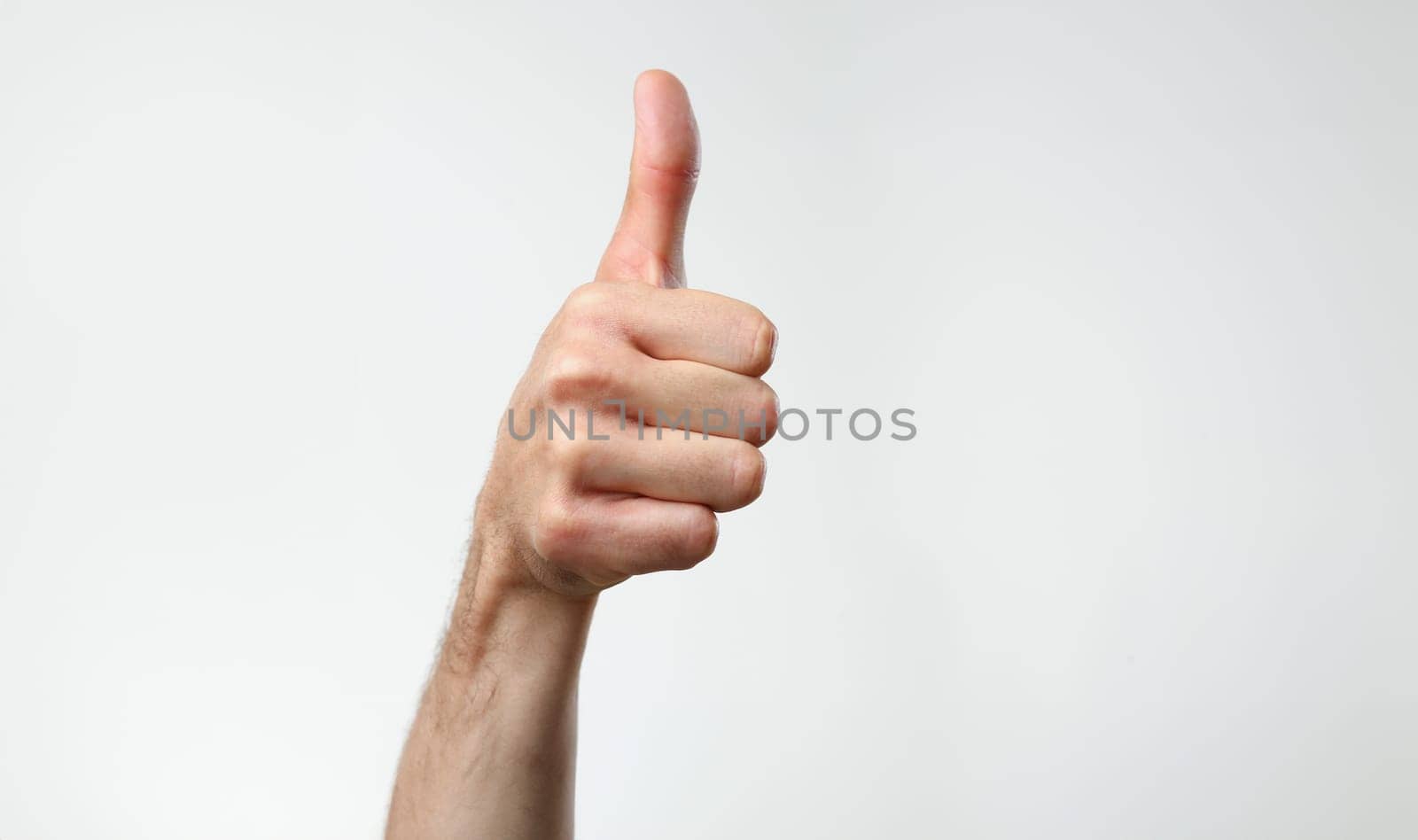 A male hand on a gray background holds by kuprevich