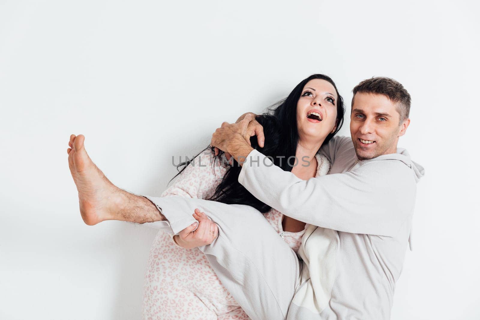 Man and woman in pajamas in the morning in a room in love husband and wife