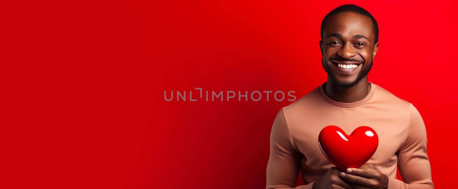 Happy, elegant, laughing, carefree man African American black guy with heart on red background for Valentine's day, banner, advertisement. Valentine's day, newlyweds, engagement, holiday, birthday, wedding, anniversary, surprise, date.