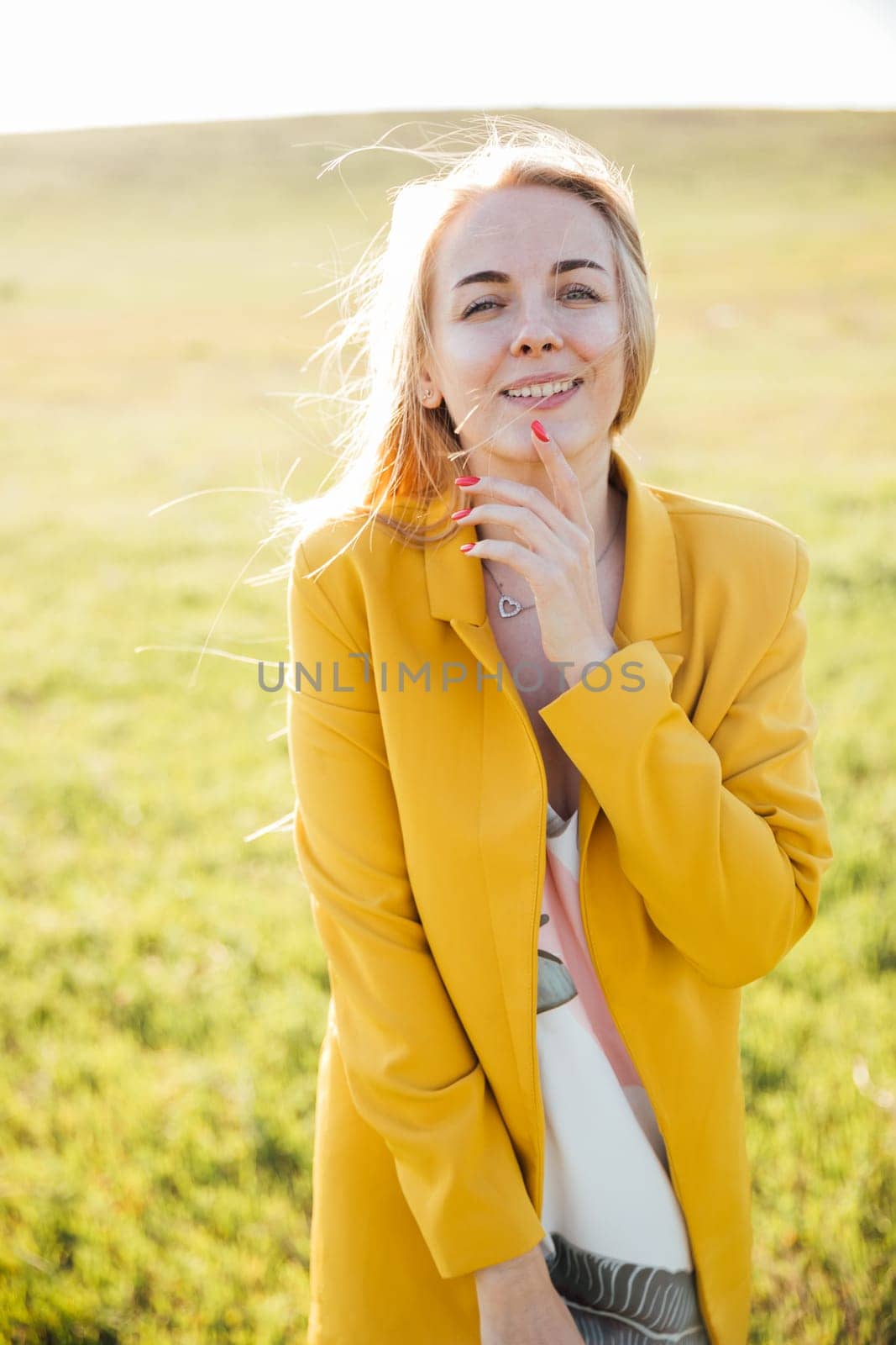 blonde in nature in the field walk journey