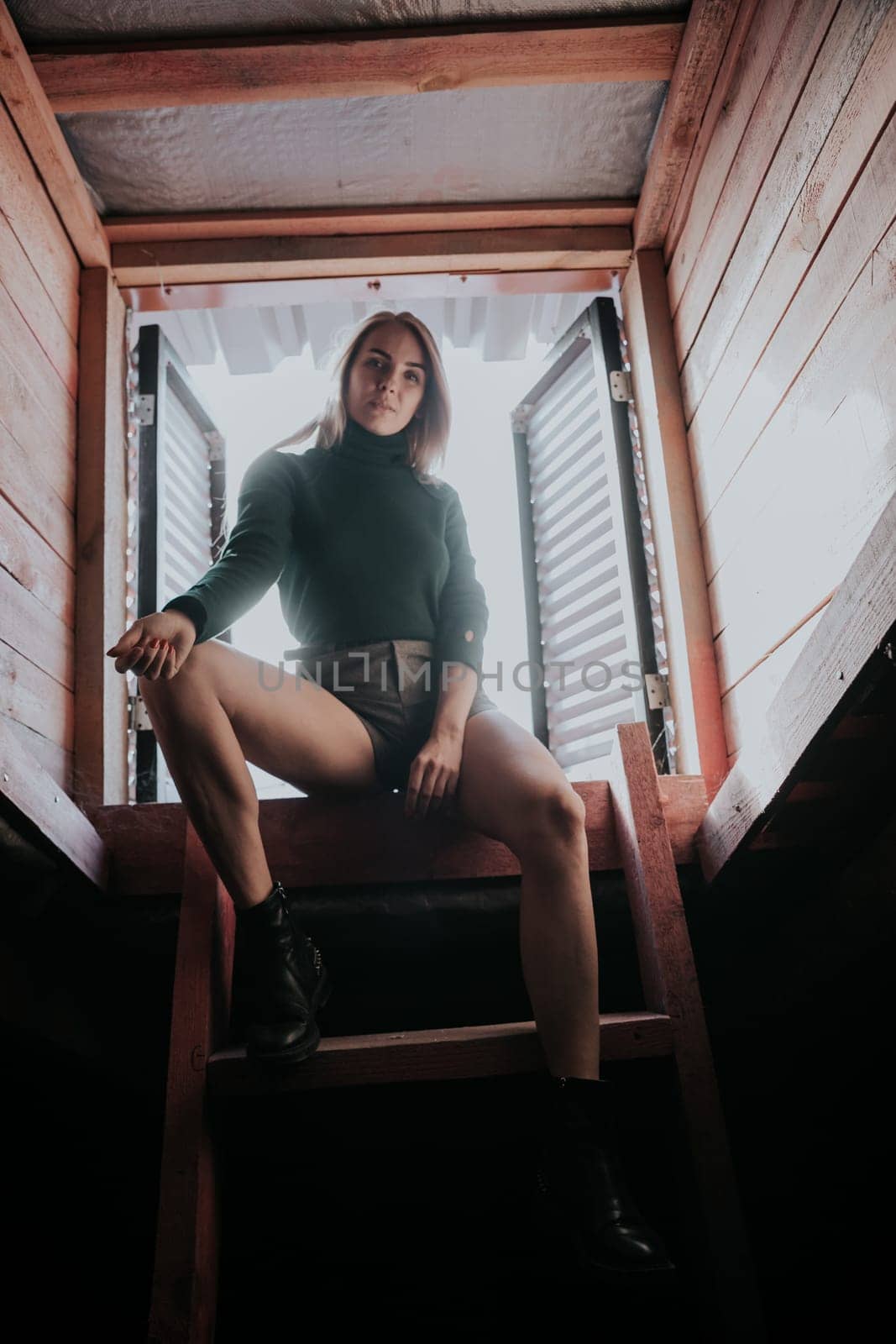 woman sitting on attic stairs