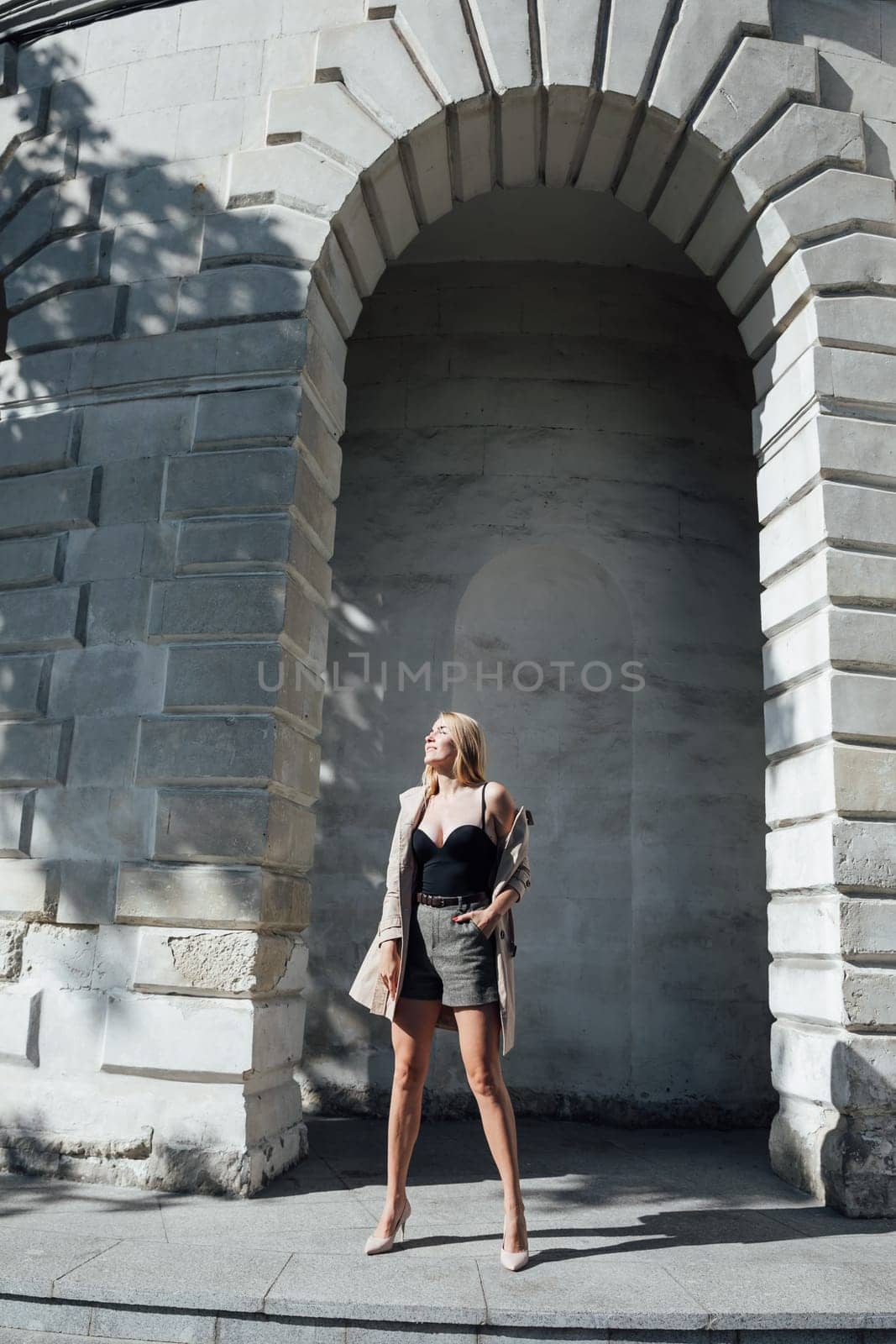 blonde on a walk near the stone walls
