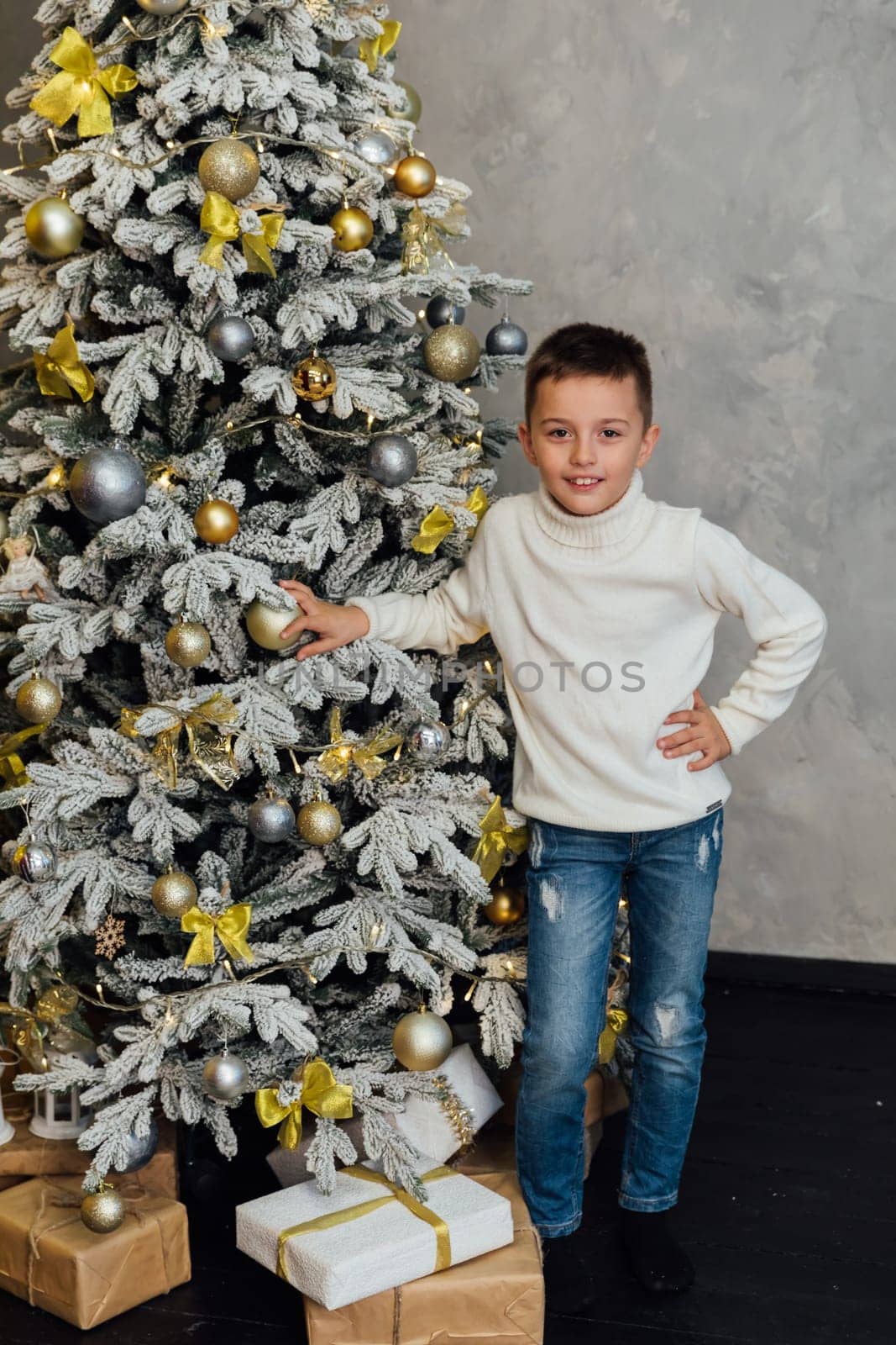 Boy at christmas tree gifts and toys