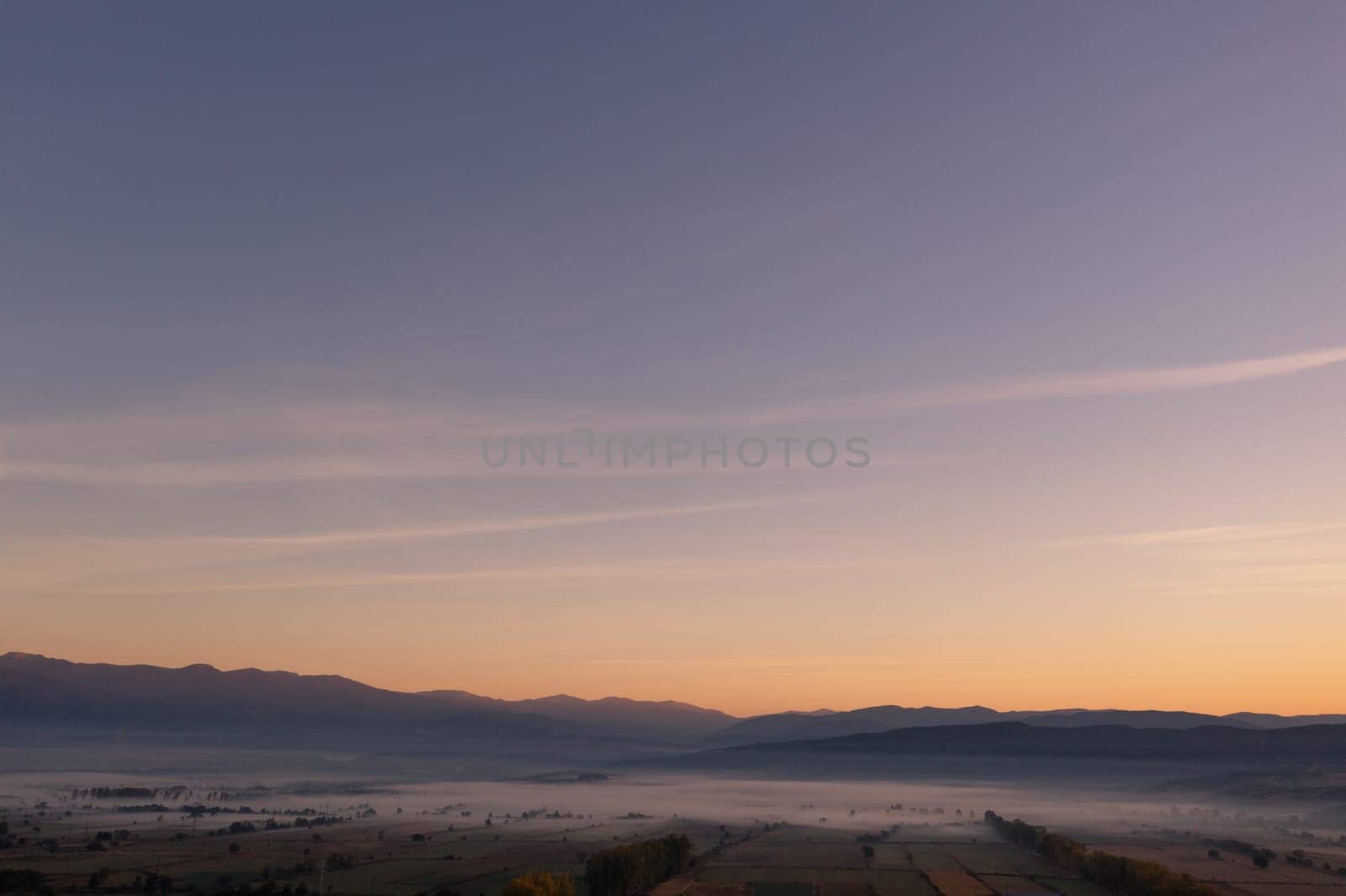 aerial view of foggy morning autumn mountains with clouds bansko bulgaria.