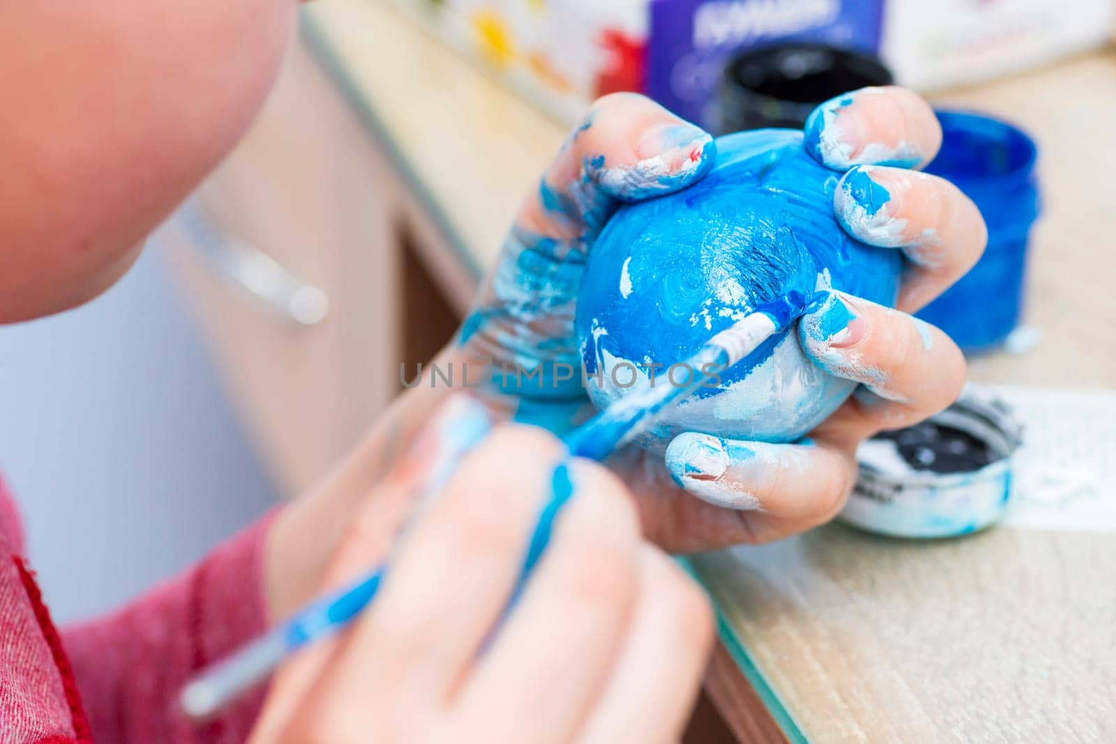 Happy easter. A boy painting Easter eggs at home. A child preparing the easter eggs for Easter.