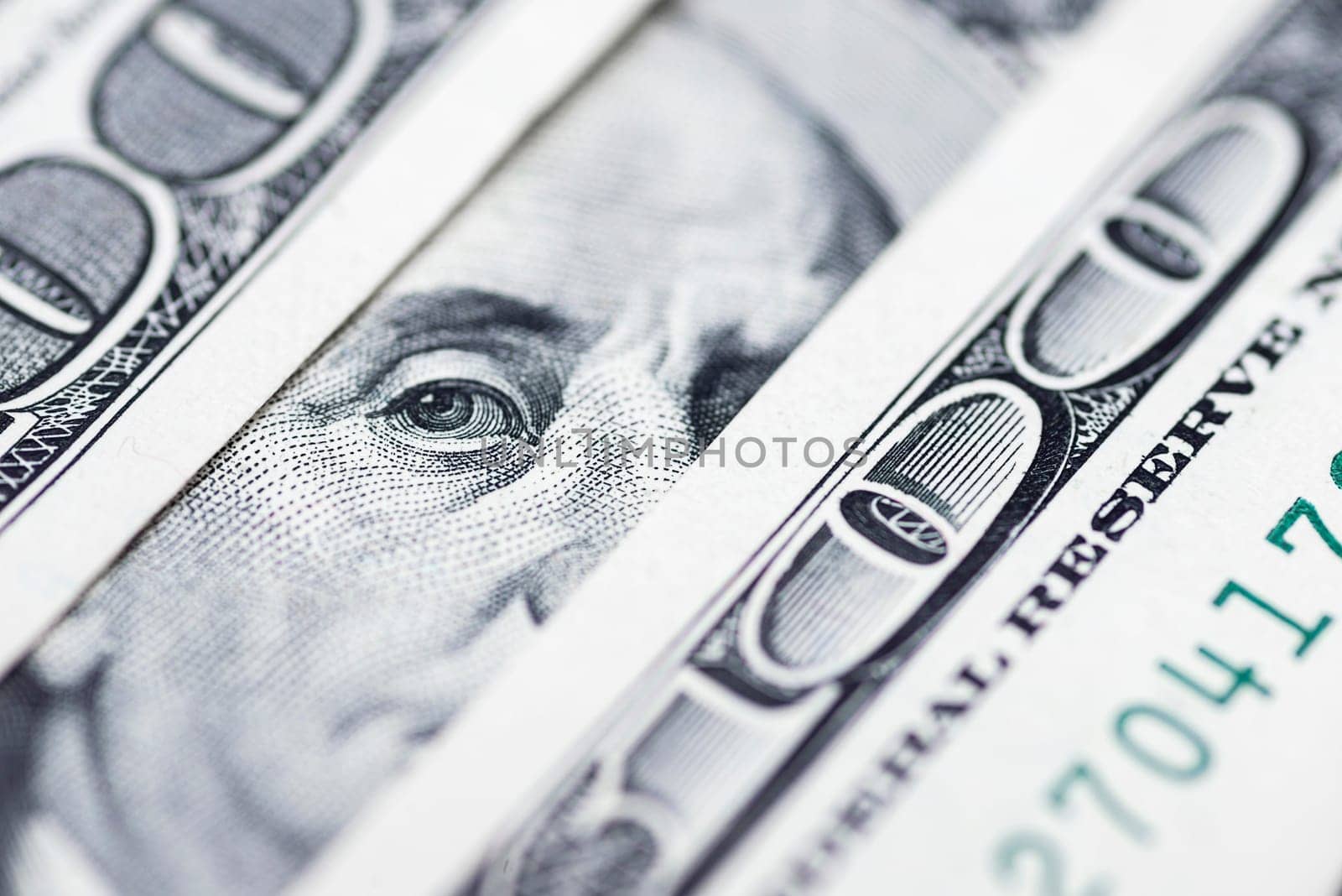 Benjamin Franklin's eyes from a hundred-dollar bill. The face of Benjamin Franklin on the hundred dollar banknote, backgrounds, close-up. 100 dollar bill with only eyes of Benjamin Franklin