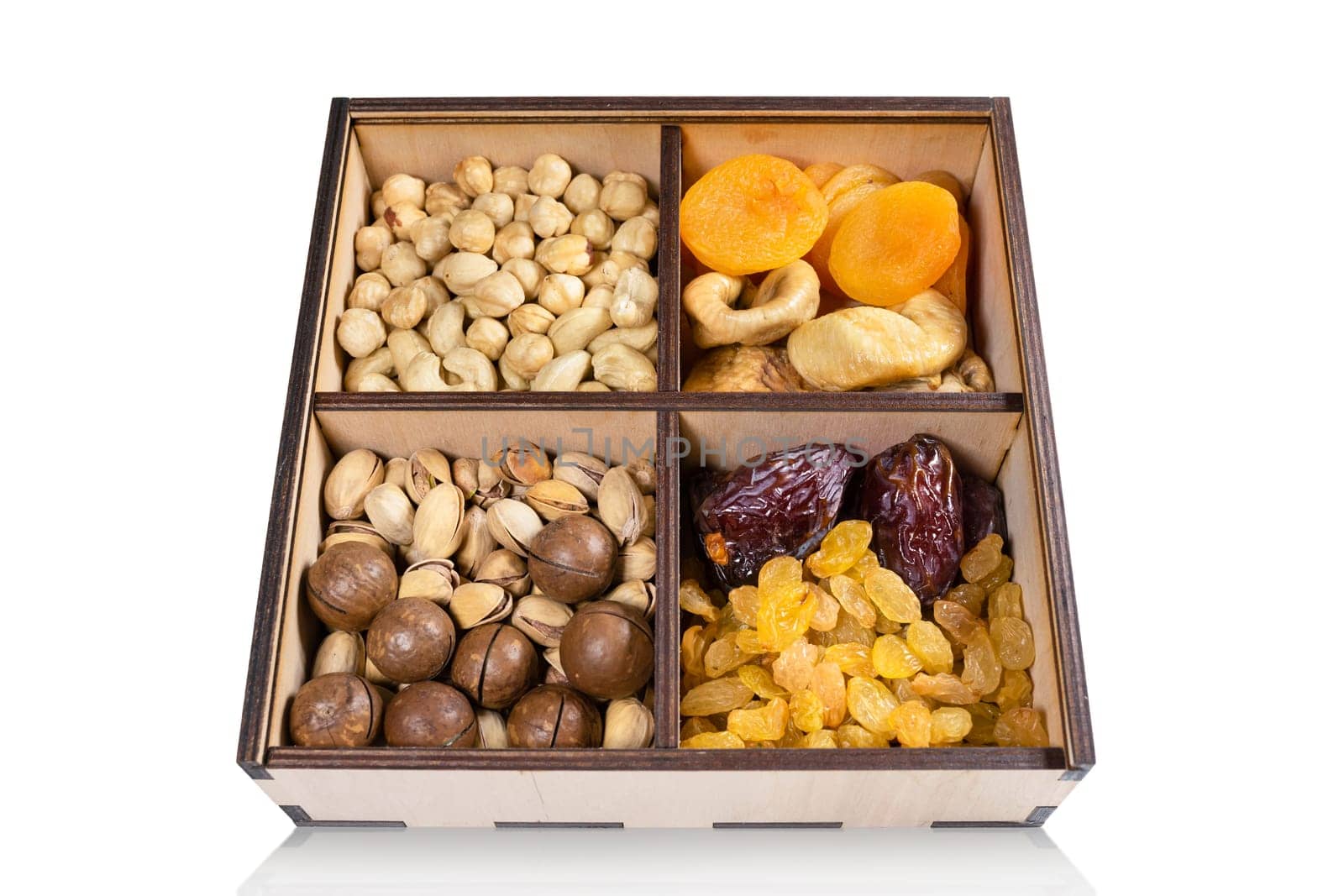 Various dried fruits in a box isolated on white background. Close-up by Shablovskyistock