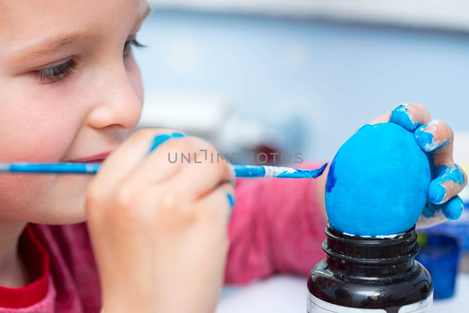 Happy easter. A boy painting Easter eggs at home. A child preparing the easter eggs for Easter.