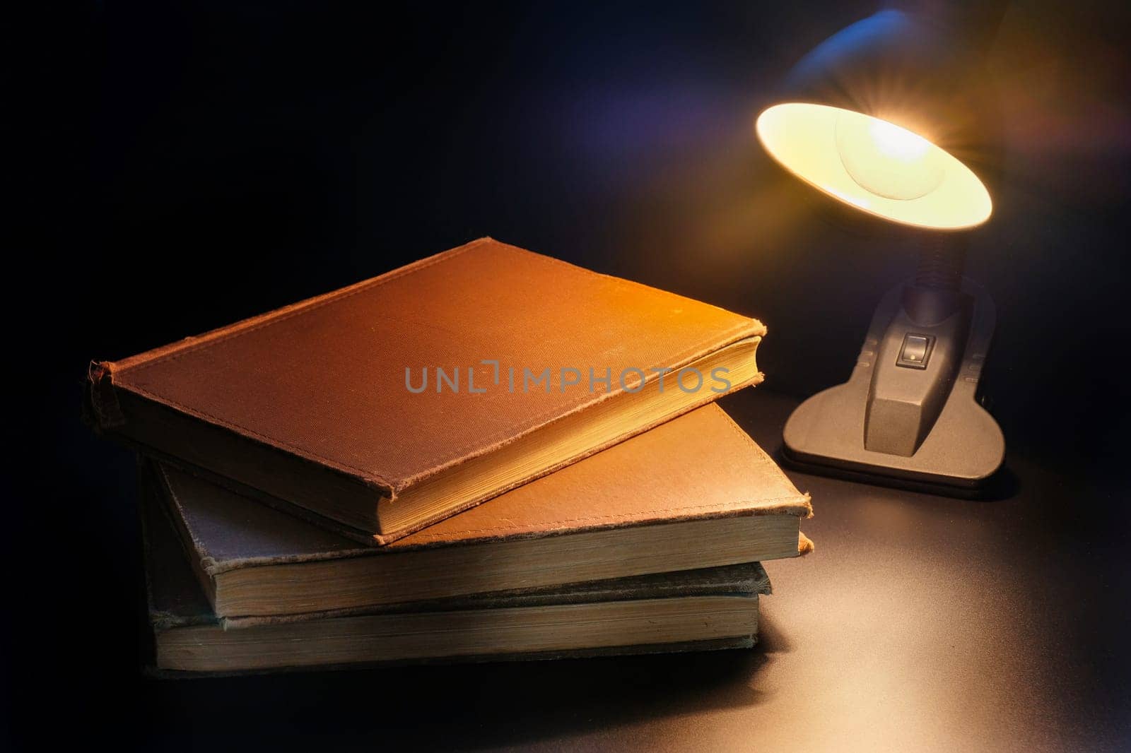 Table lamp lighting books on the table. Education concept.
