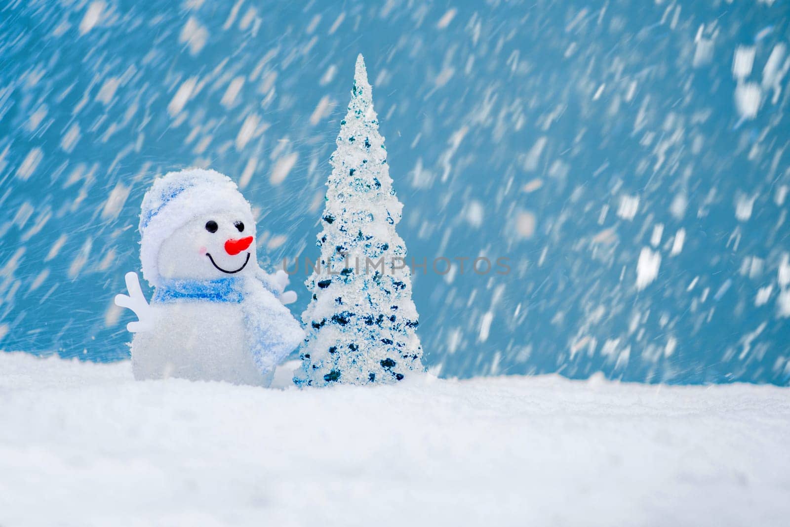 Happy snowman with Christmas tree in winter scenery with copy space. Christmas background with snowman.