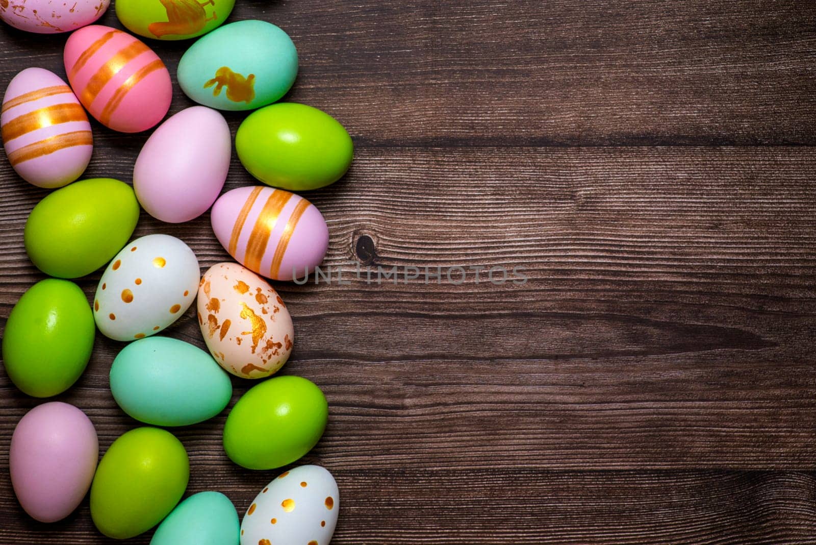Easter eggs on wooden background. Colorful Easter eggs on a wooden background of boards.