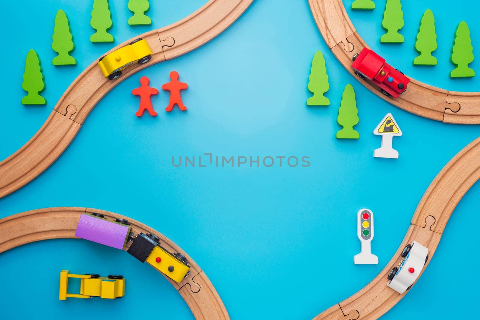 Baby kid toys background. Toy train and wooden rails on blue background by andreyz