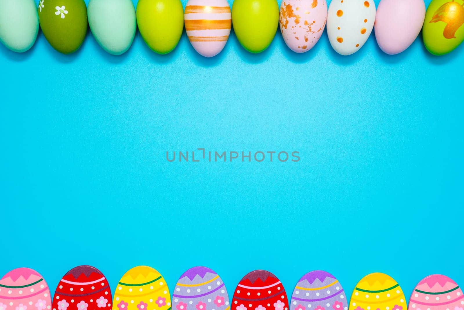 Easter Eggs. Colorful Easter eggs on blue background with copy space by andreyz