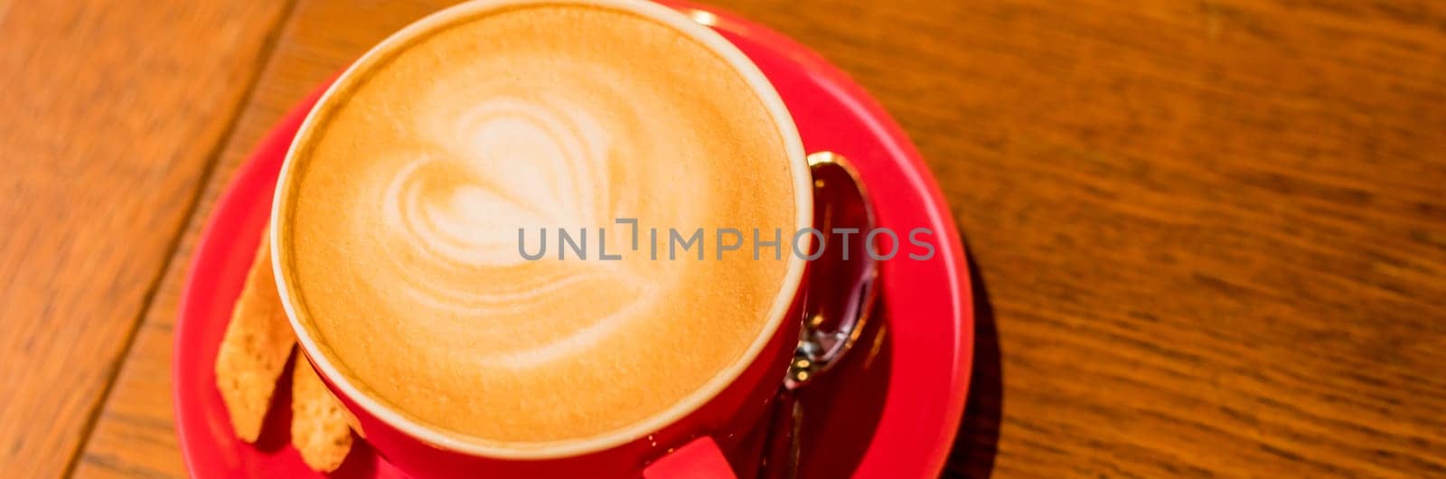 Latte Art,Side view of hot coffee isolated on wooden background.Morning with a red cup of coffee or cappuccino. Art and craft coffee. web banner. Happy valentines day by YuliaYaspe1979