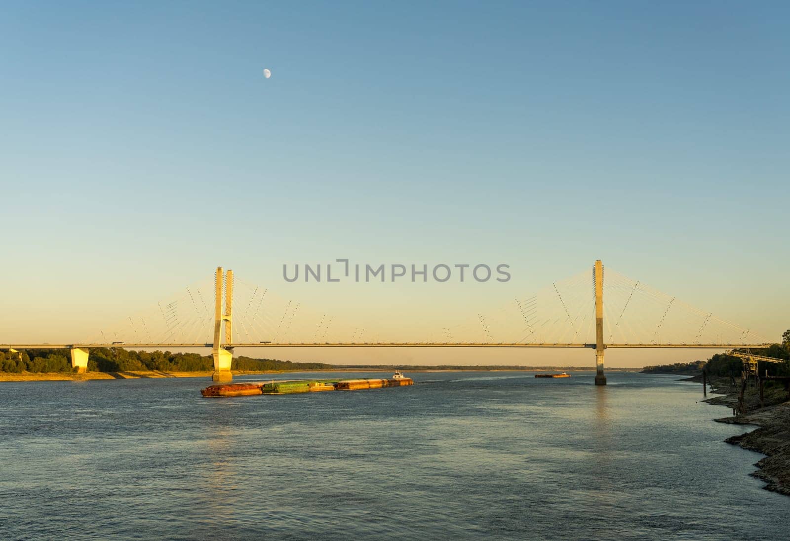 Modern Greenville bridge across the Mississippi to Arkansas with barge by steheap