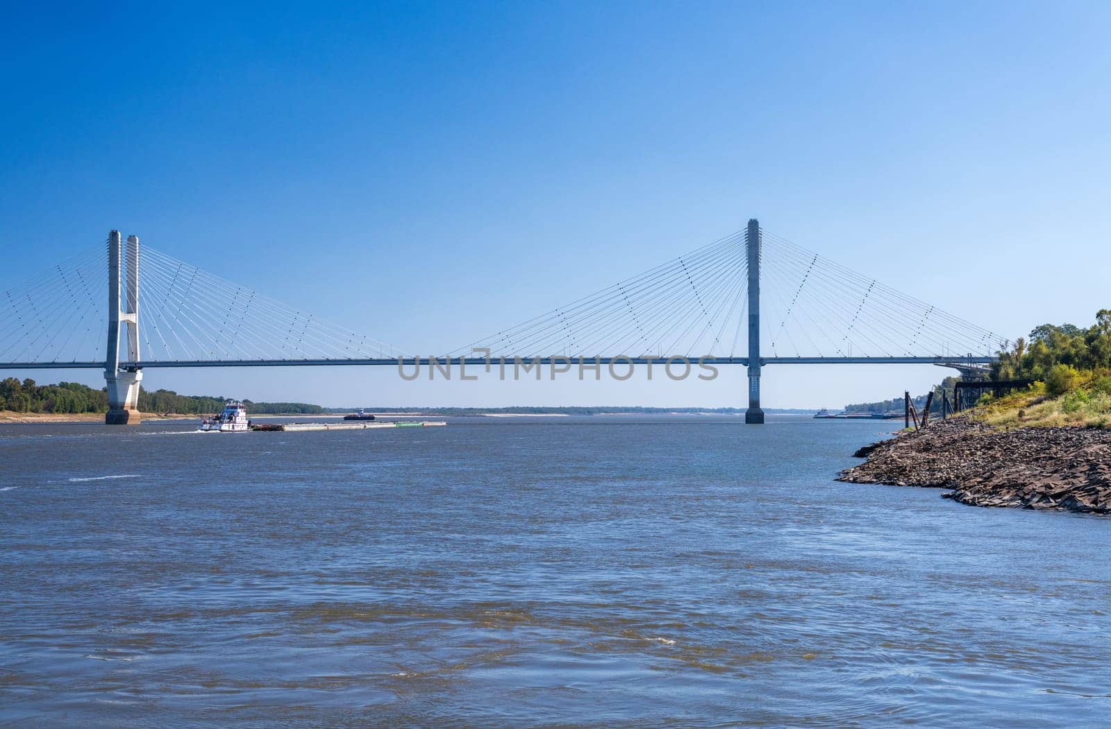 Modern Greenville bridge across the Mississippi to Arkansas with barge by steheap