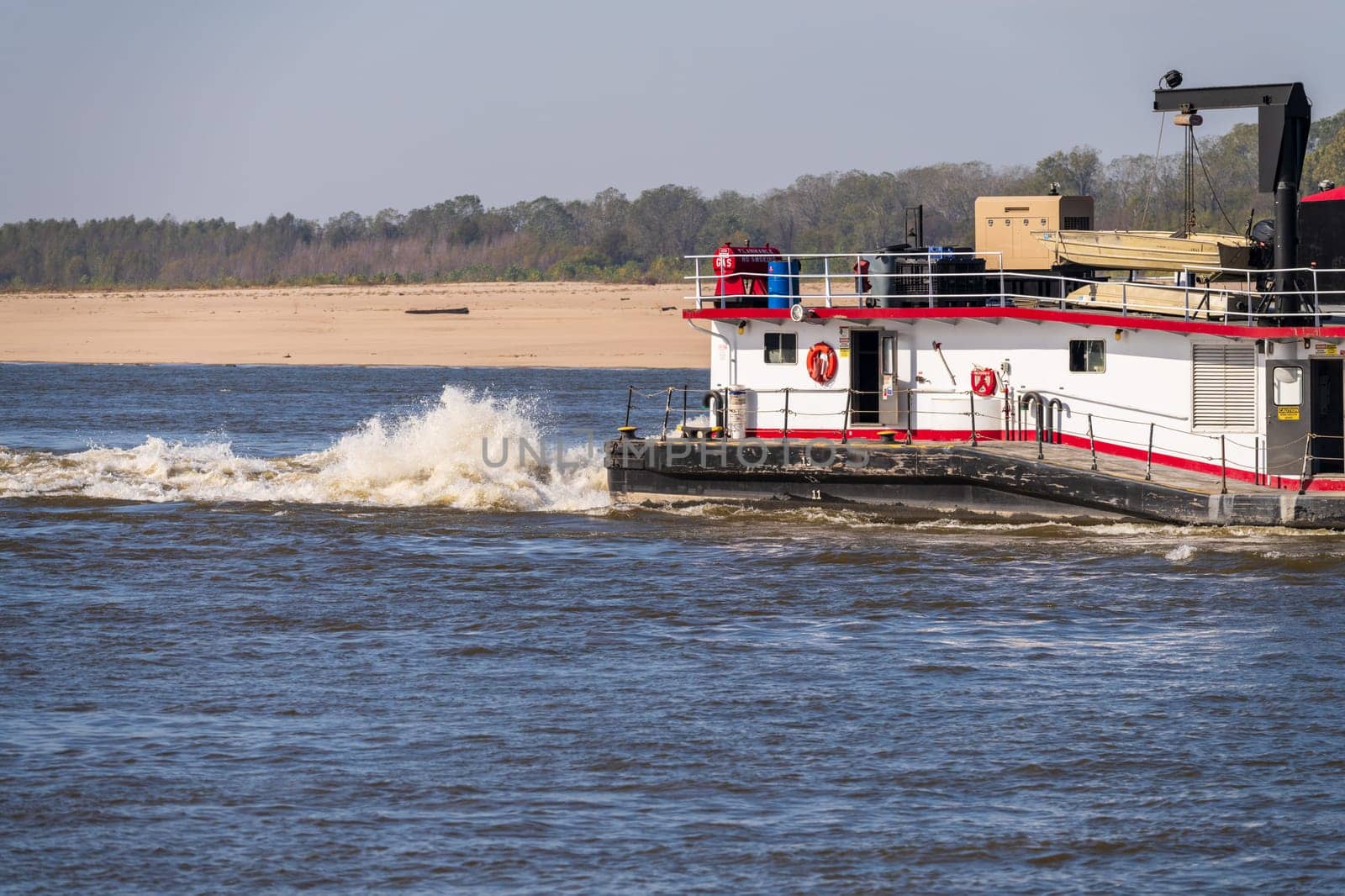 Rear of Mississippi river pusher boat churning the water by steheap