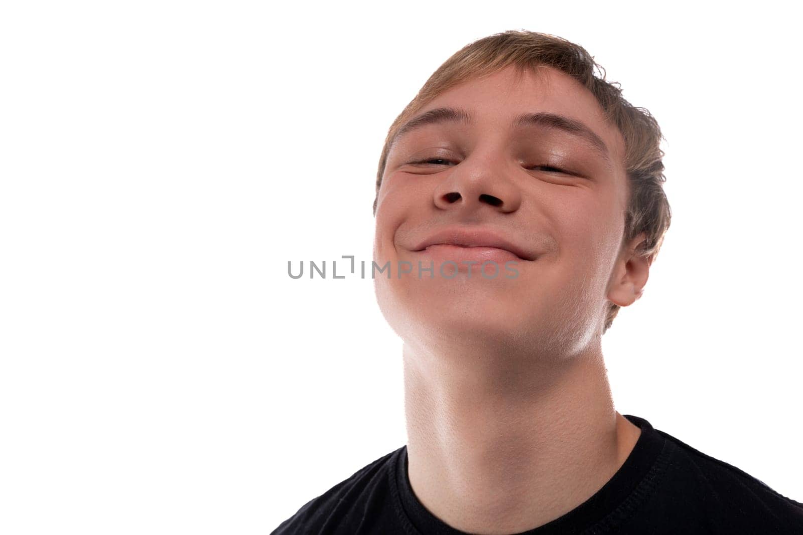 Satisfied teenage guy with brown hair closed his eyes by TRMK