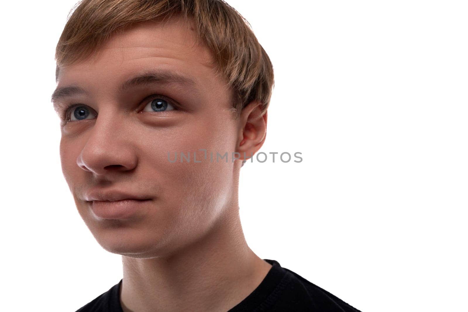 Headshot portrait of a blond teenager young man with short hair.