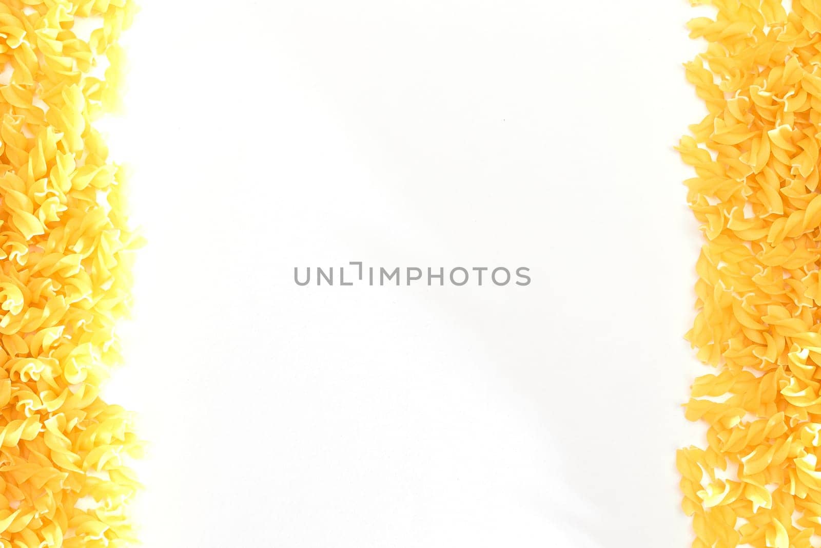 Uncooked Fusilli Pasta with Copy Space by InfinitumProdux