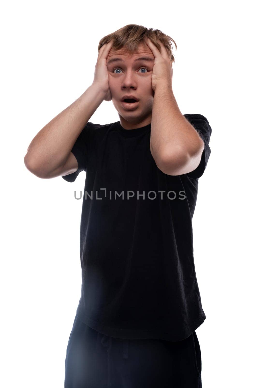 Teen boy dressed in a black t-shirt is excited and puzzled.
