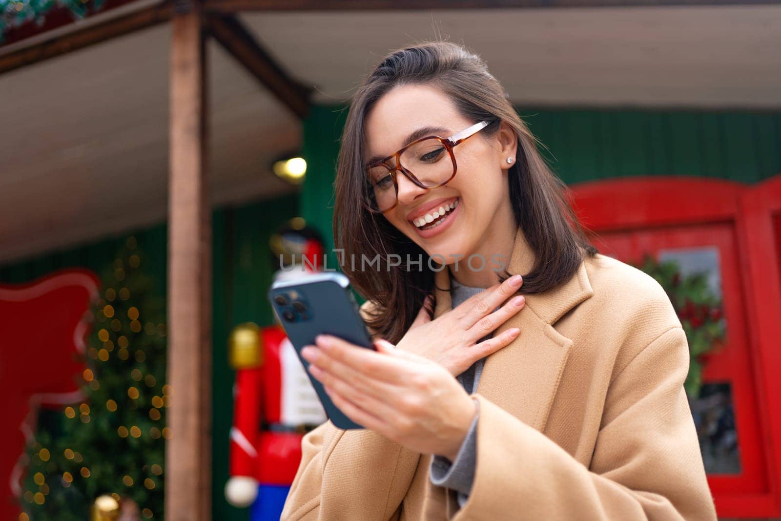 Surprised woman wear eyeglasses read positive message on smartphone by andreonegin