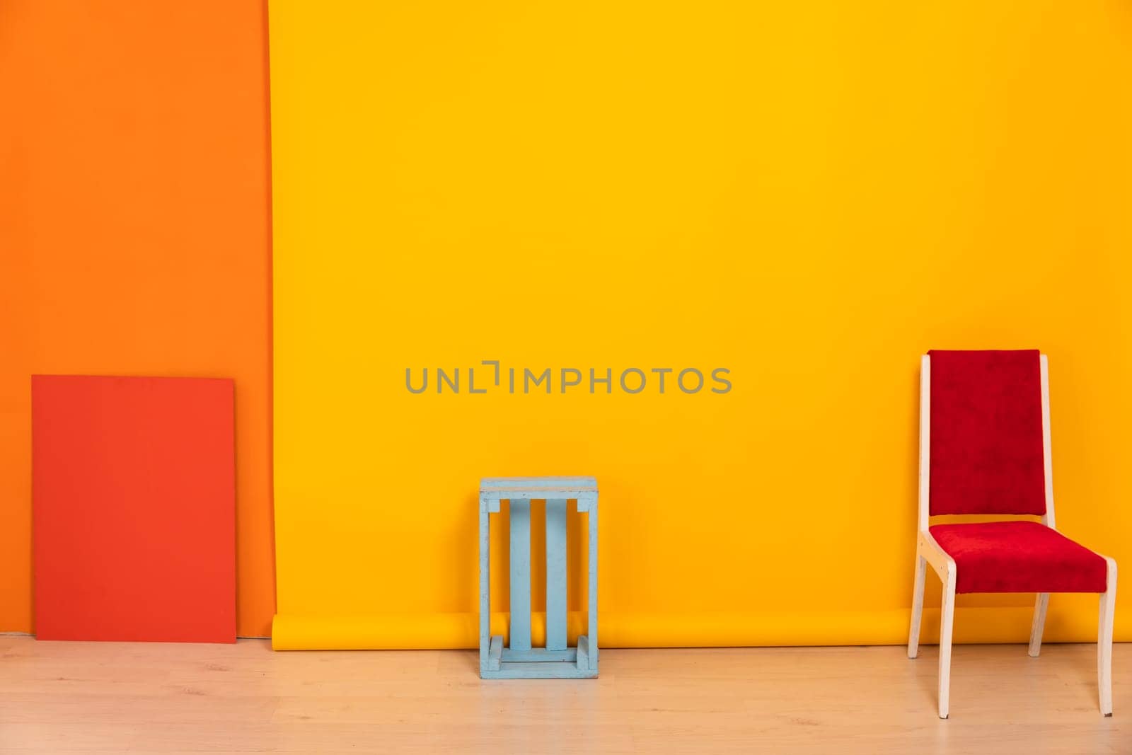 red chair against a yellow-orange wall