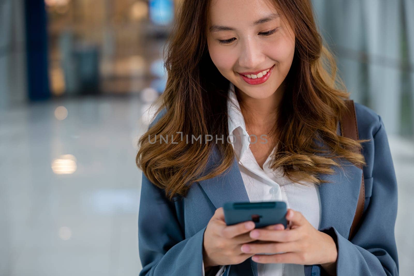 Female hands typing message on smartphone by Sorapop