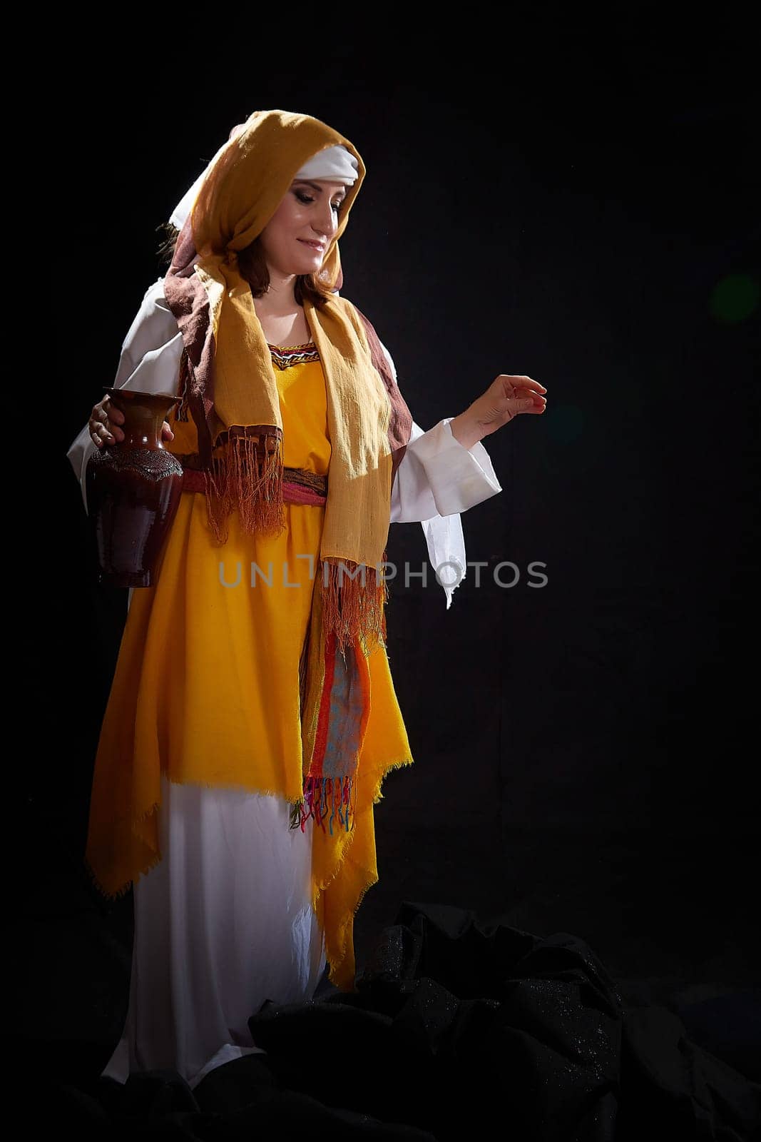 A girl or a young woman from ancient Israel, Palestine, Iran, Iraq with a clay jug. A biblical story with Rebekah and water. Stylized photo shoot with a model in Middle Eastern clothes by keleny