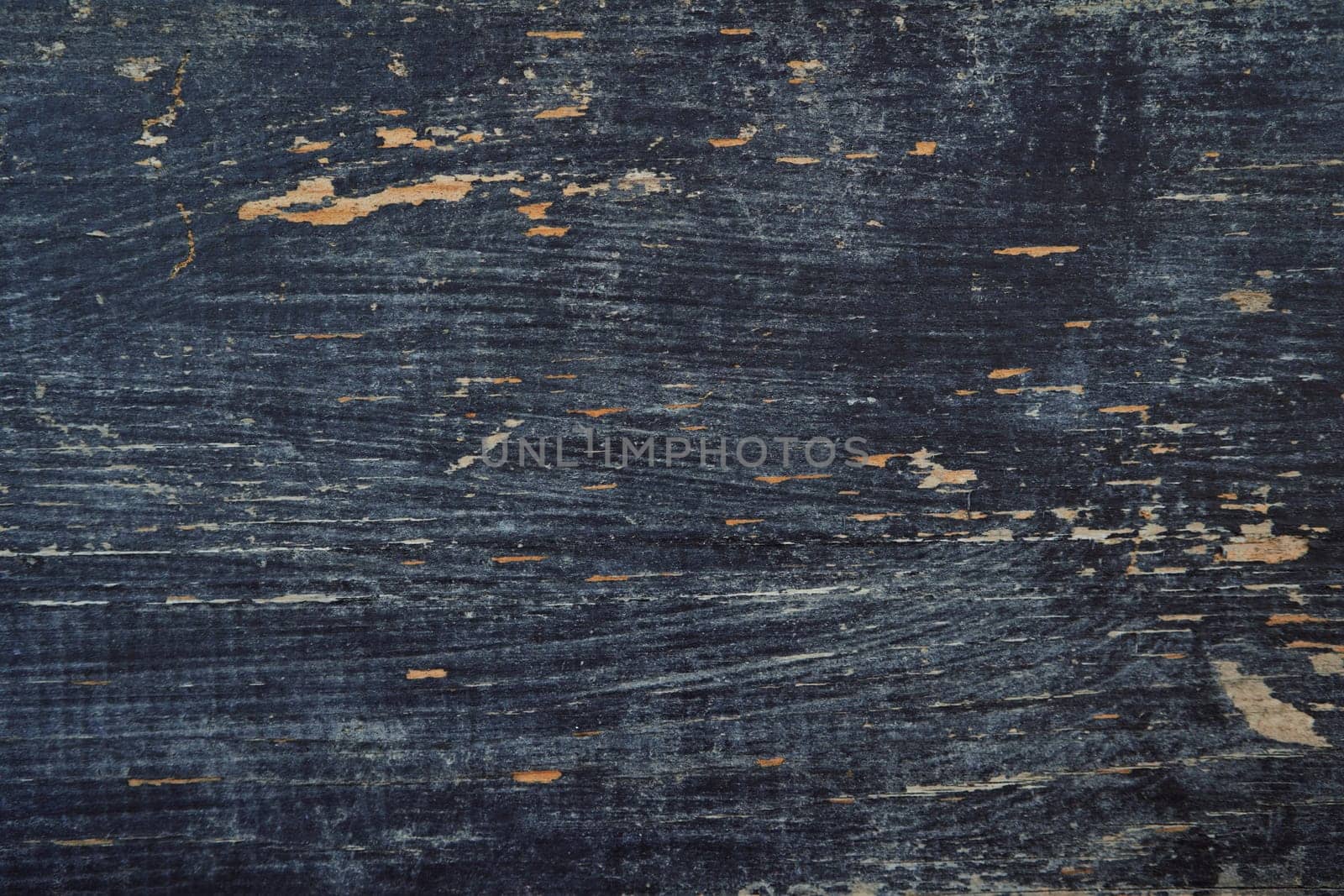 Black paint has peeled off the old wood planks, revealing the light color by Nadtochiy