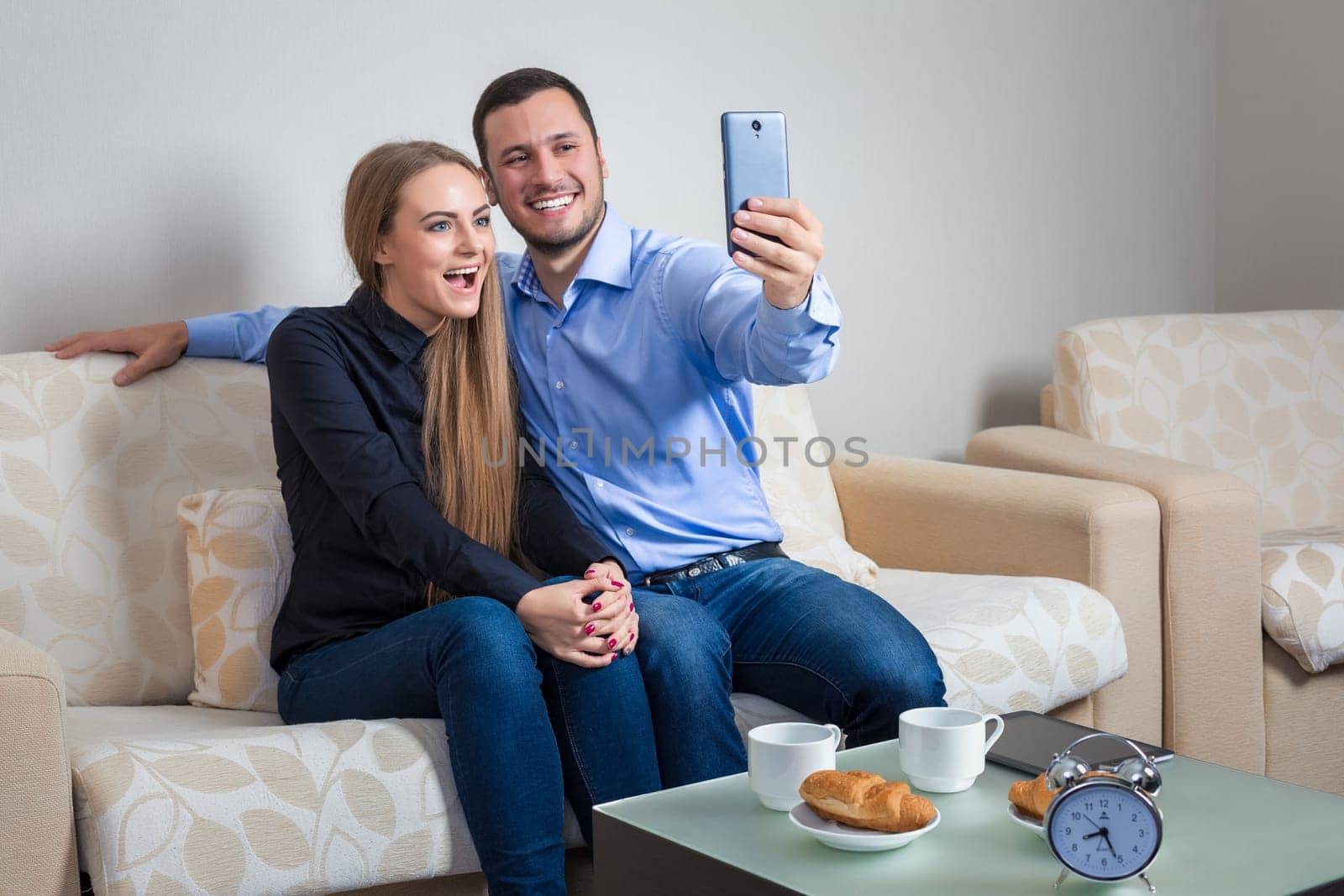Beautiful young man and woman doing selfie with telephone camera by nazarovsergey