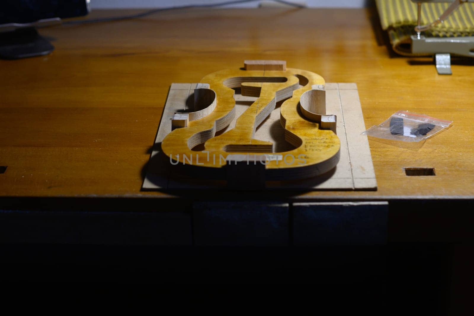 violin mold on work desk at luthier lab, center bot, corner blocks , bend ribs for a new classic handmade violin