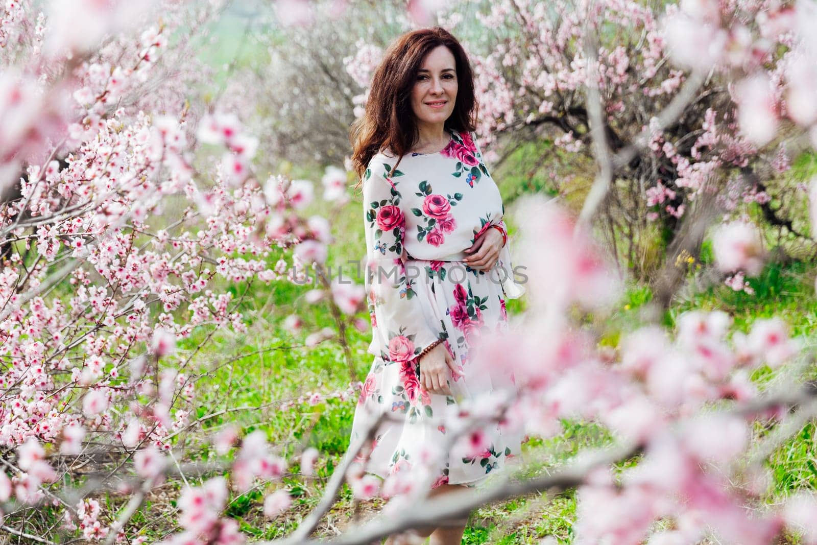 spring nature travel walk beautiful woman brunette in flowering trees by Simakov