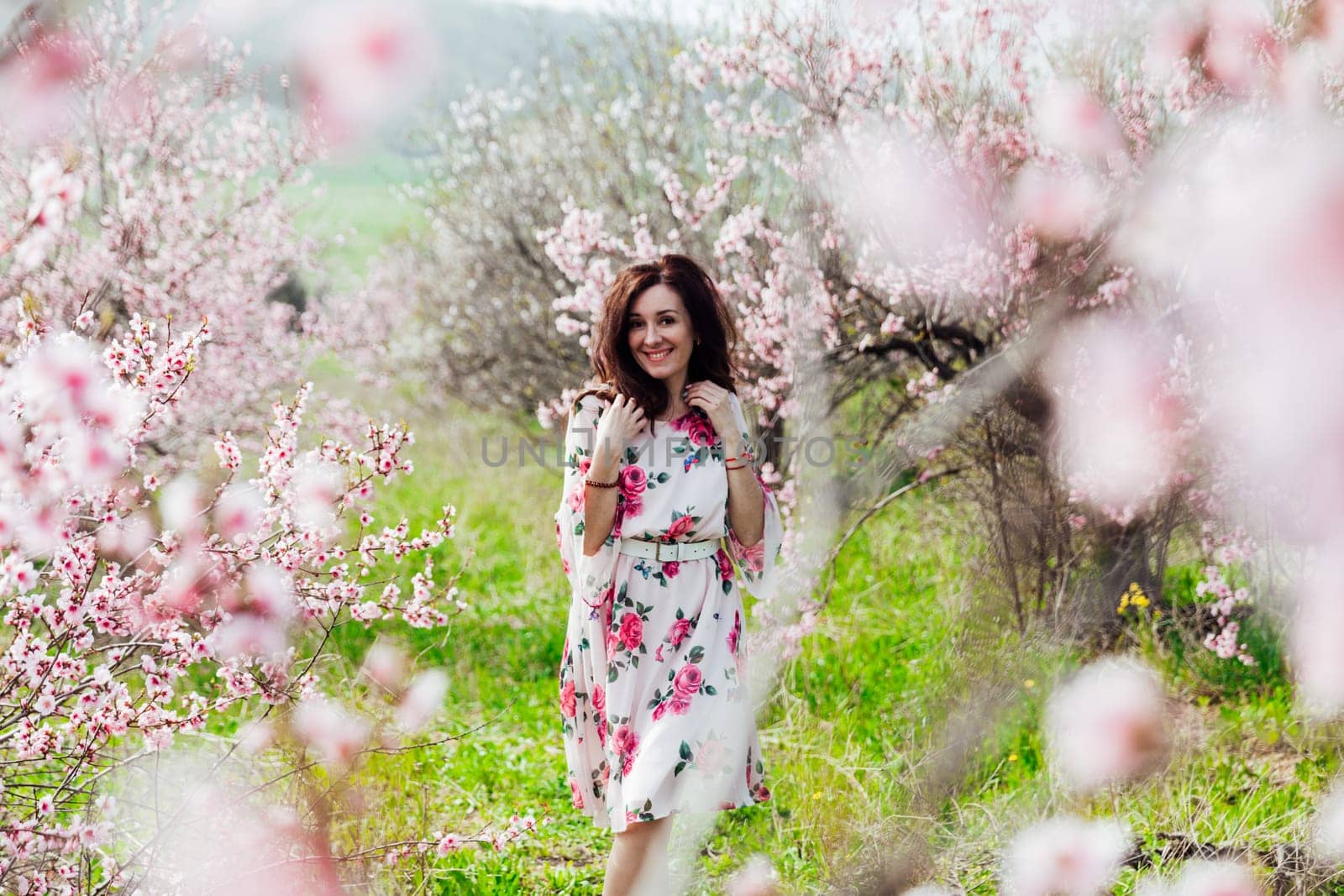 spring nature travel walk beautiful woman brunette in flowering trees by Simakov